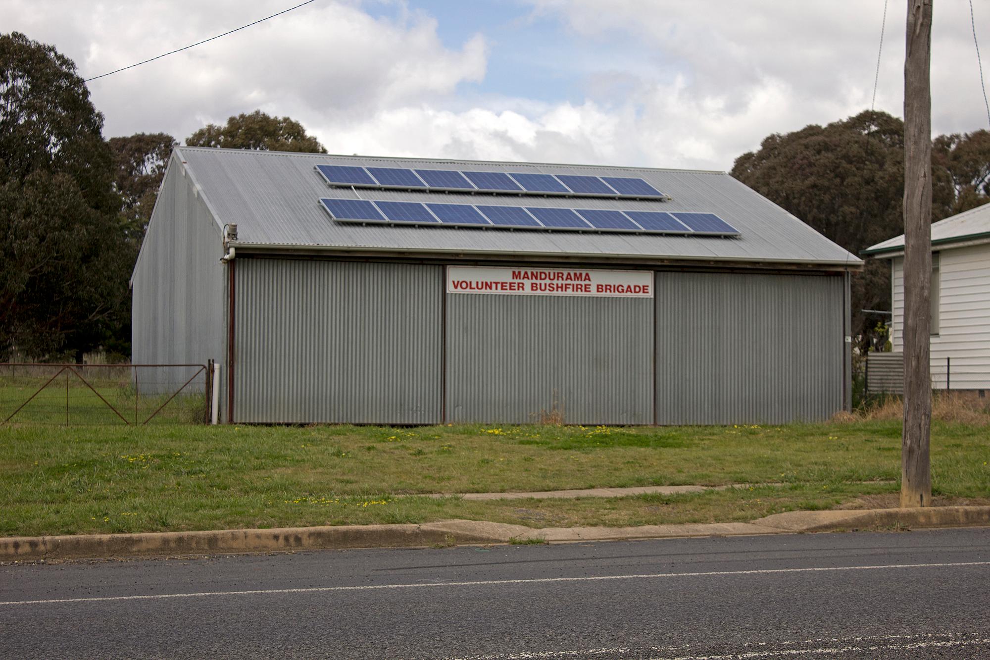 Solar panels bolted on metal industrial shed roof